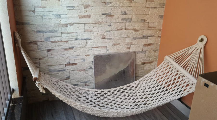 A balcony featuring hammocks that adds a unique and cozy element.