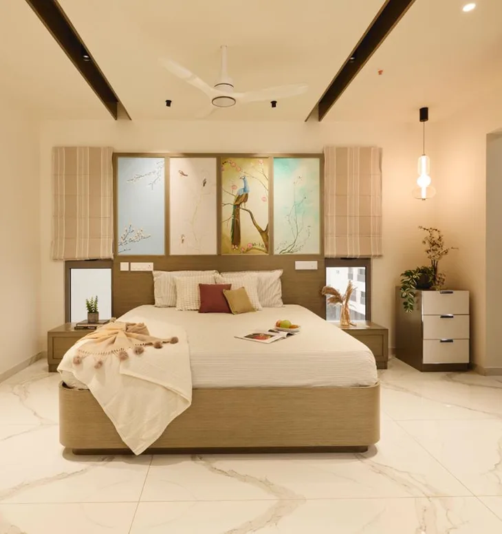 A master bedroom featuring wall with personalized artwork,ceiling with concealed lighting adding warmth and a relaxing ambience