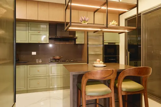 A well-designed kitchen featuring breakfast counter, ample storage and integrated appliances.